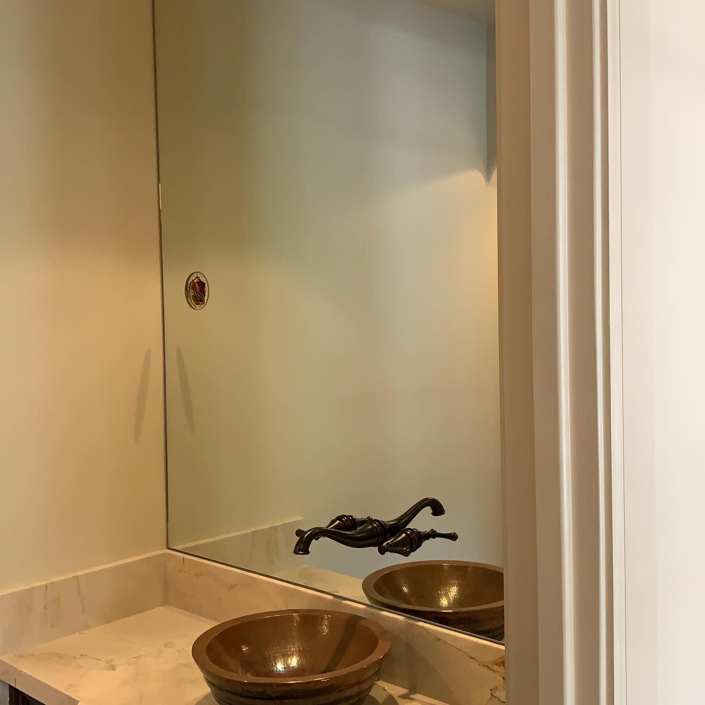 A bathroom with two sinks and a large mirror