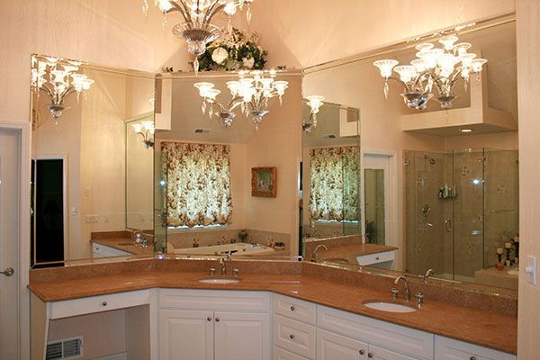 A bathroom with two sinks and a large mirror