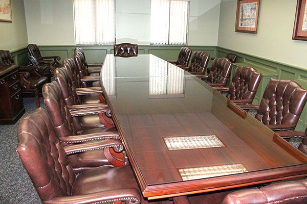 A conference room with a long table and chairs