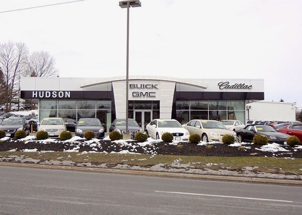 A hudson buick gmc dealership with cars parked in front of it