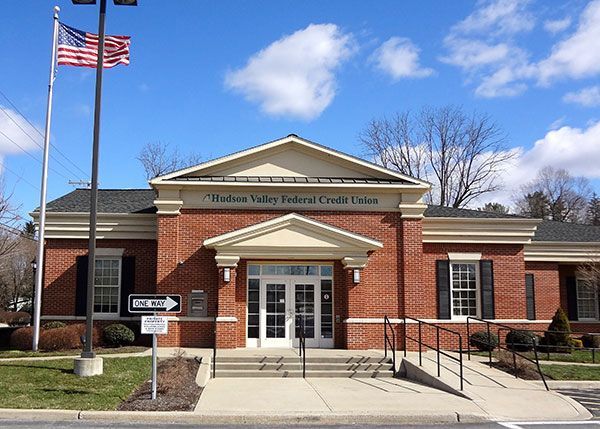 A brick building with an american flag in front of it