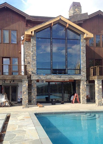 A large house with a swimming pool in front of it