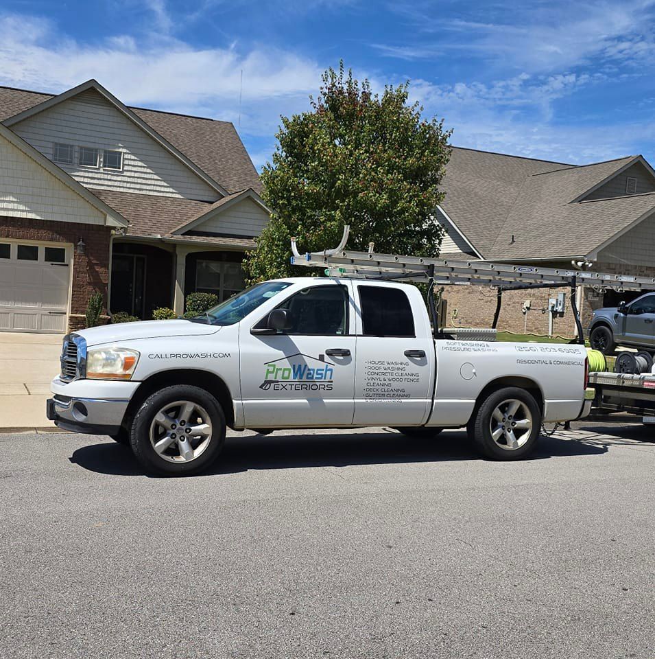 A white truck is parked in front of a house