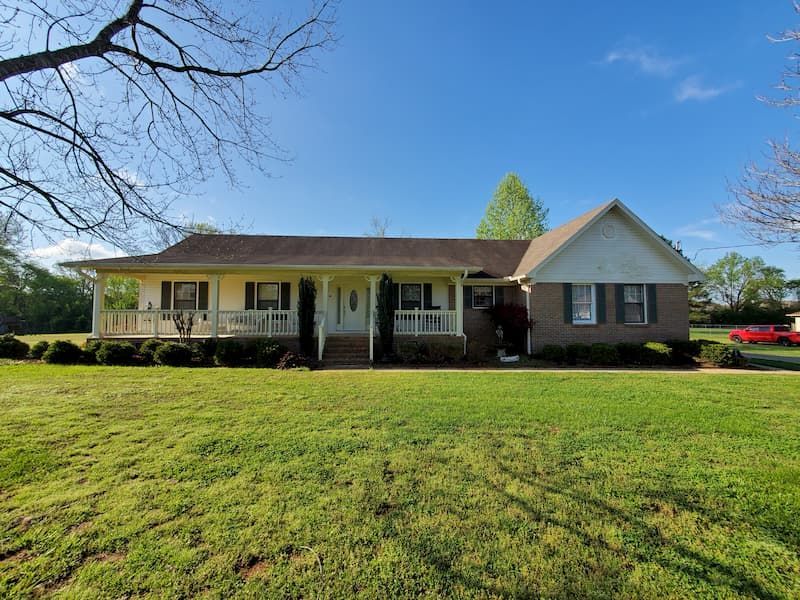 A large house with a large lawn in front of it.