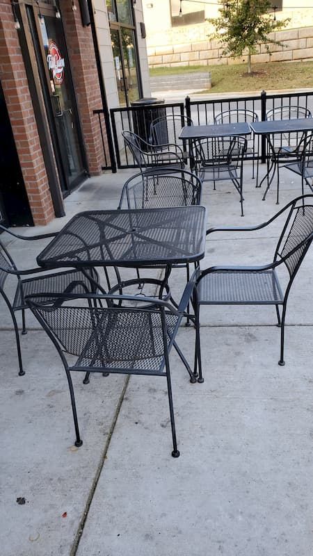 A patio with tables and chairs outside of a restaurant.