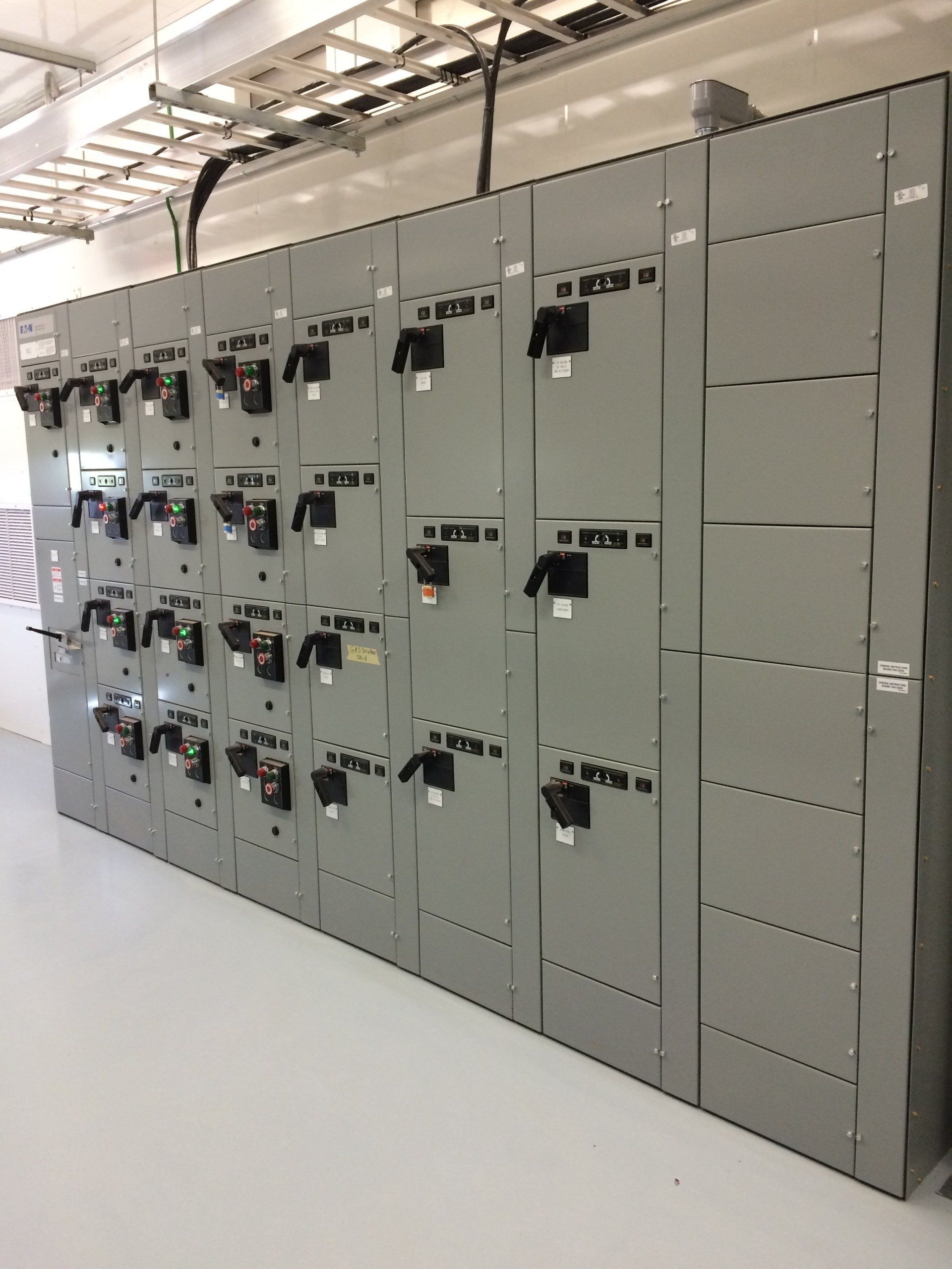 A large wall of electrical panels in a building