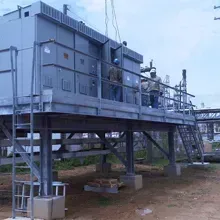 A group of people are working on a large building on stilts.
