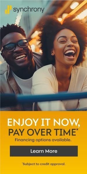 Two people laughing on a roller coaster with text: Enjoy it now, pay over time.