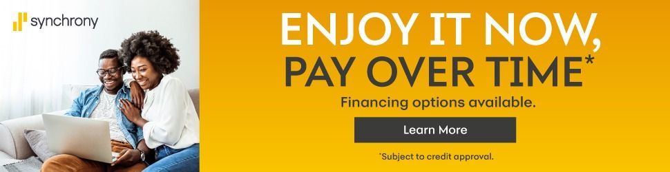 Woman with laptop on couch beside banner reading ENJOY IT NOW, PAY OVER TIME and Learn More button