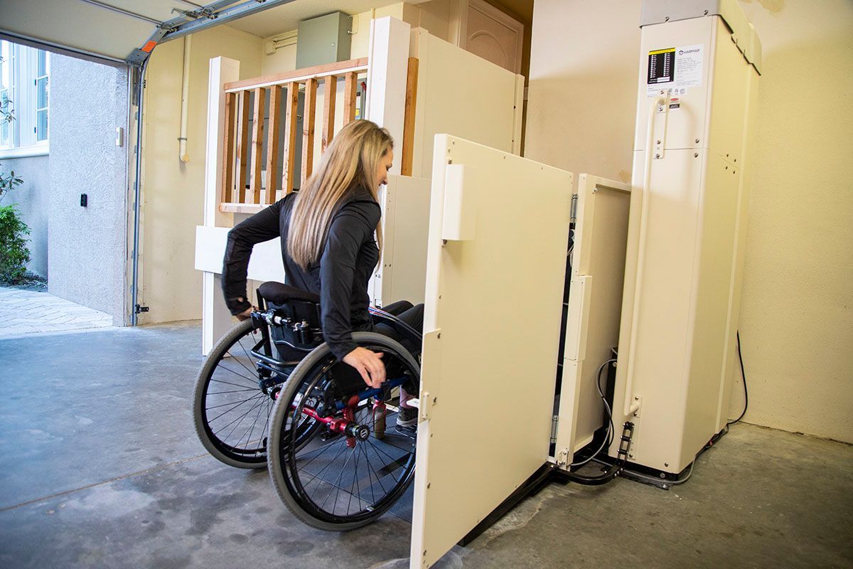 A woman trying the new platform wheelchair lift
