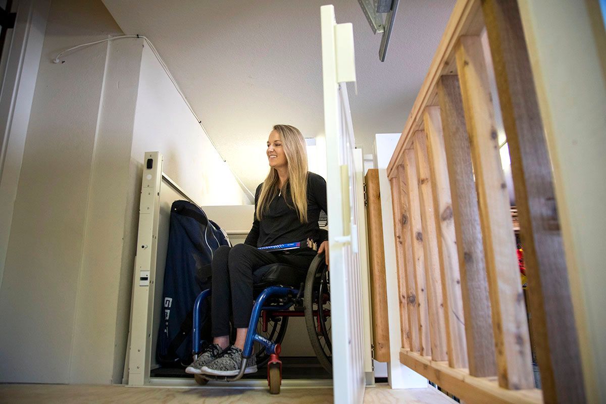 A woman on a wheelchair trying the new platform wheelchair lift