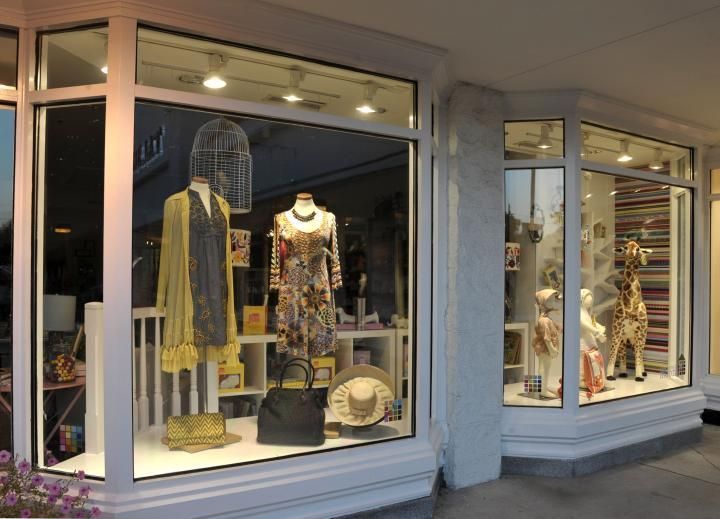 Storefront windows displaying clothing and decorative items.