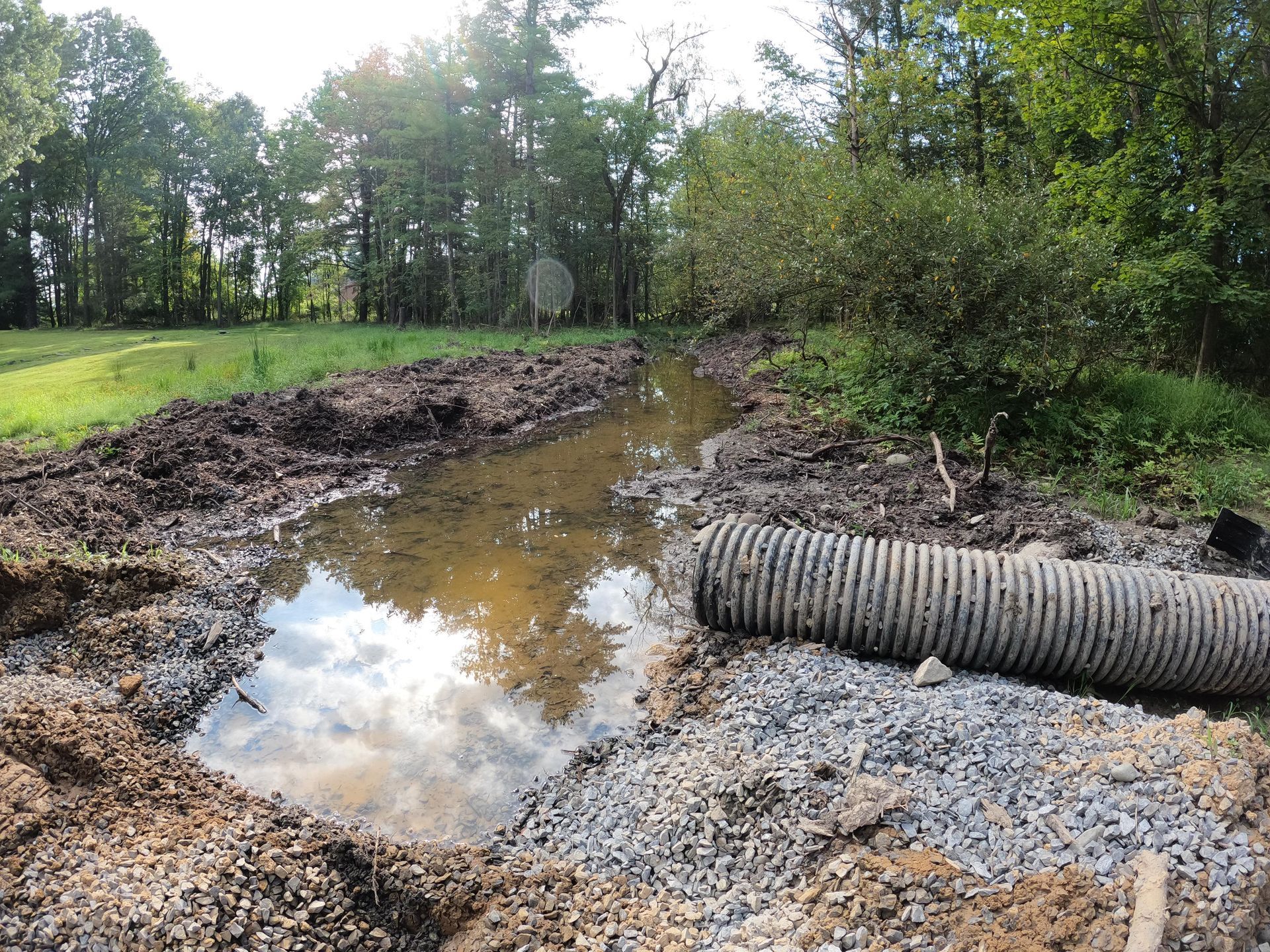 Runoff pipe draining into a trench