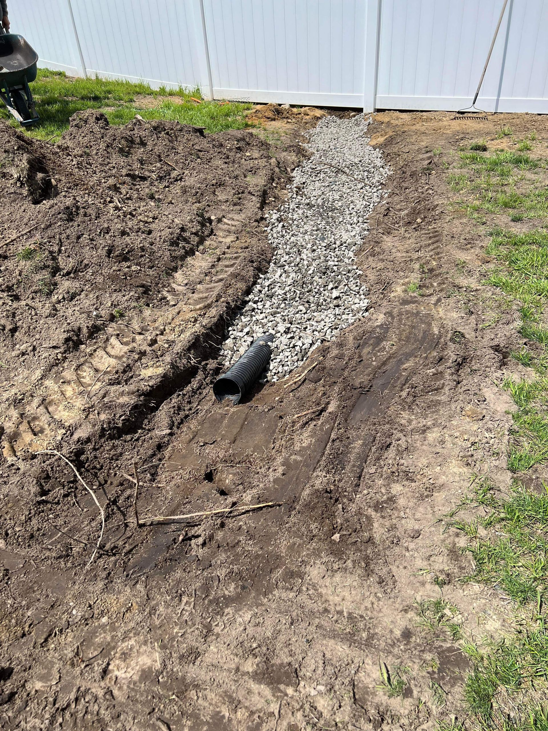 Trench with a drainage pipe.