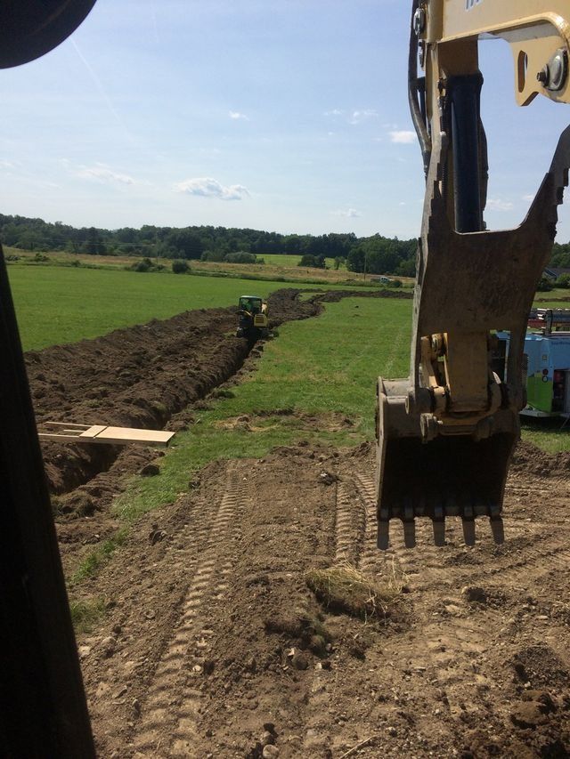 Drainage installation with excavator