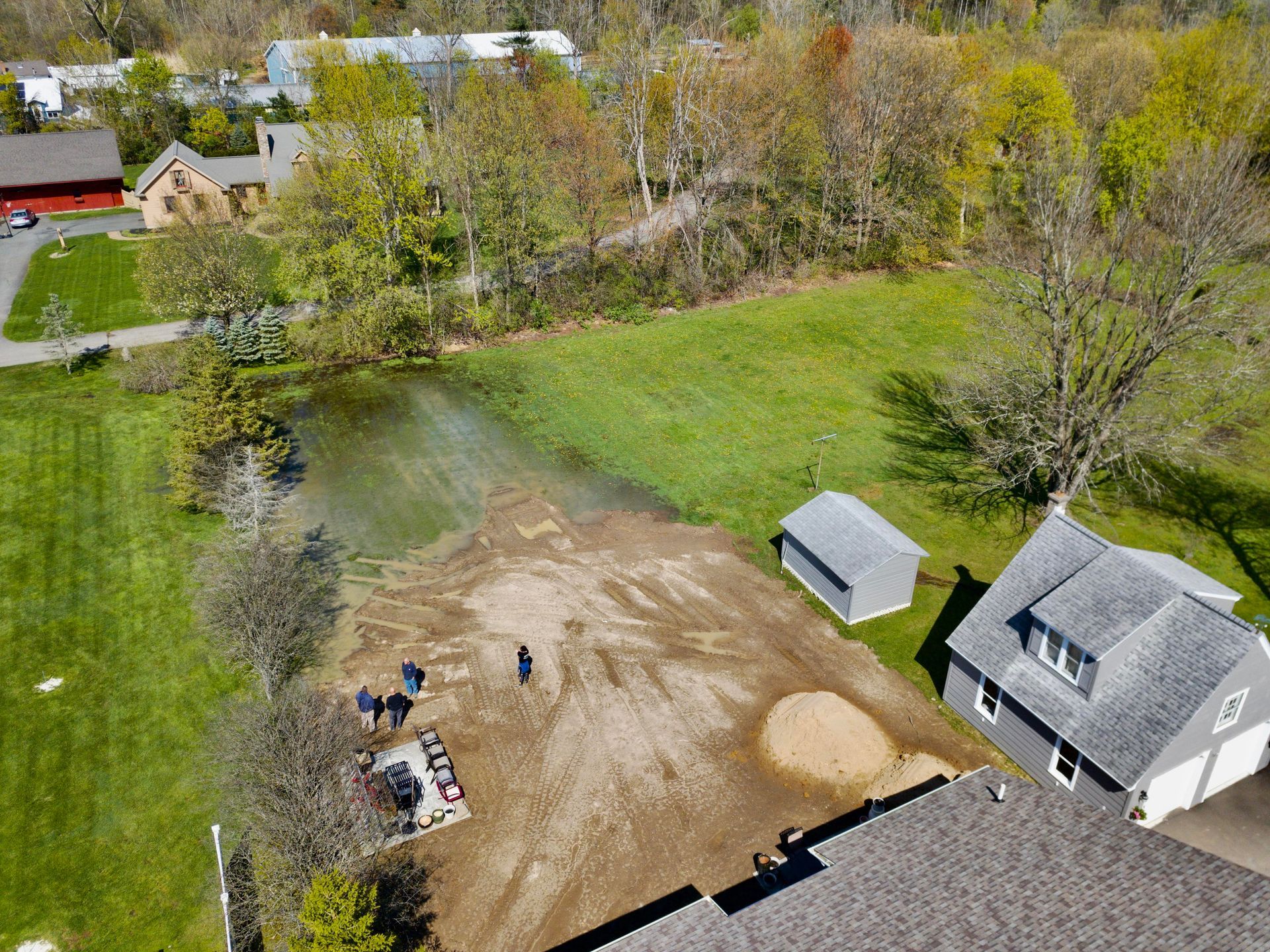an aerial view of a house and a pond in a rural area .