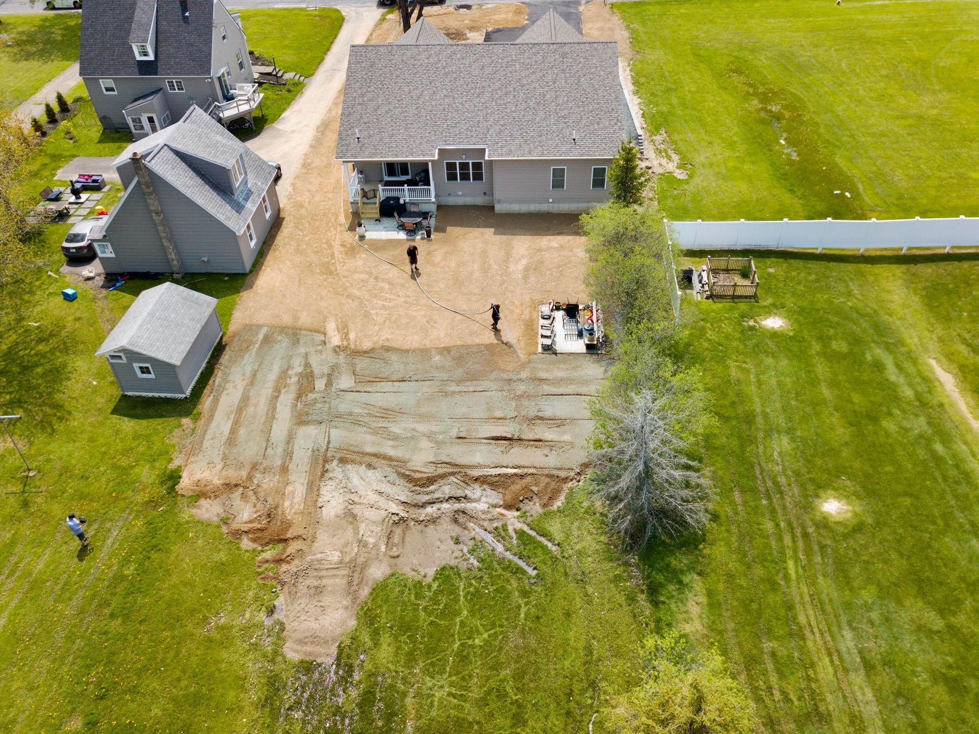 an aerial view of a house being built on a lush green field .