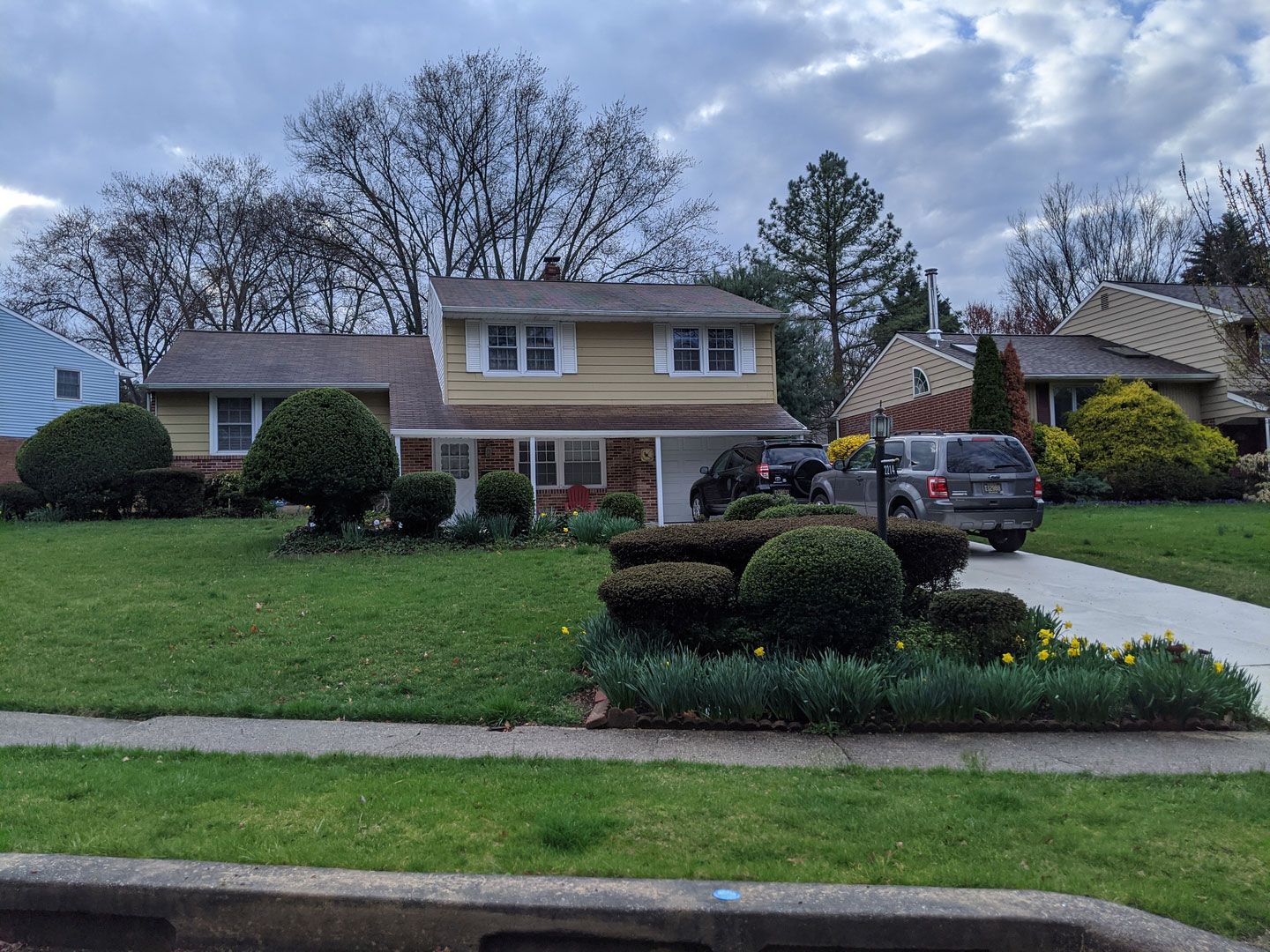A house with a car parked in front of it