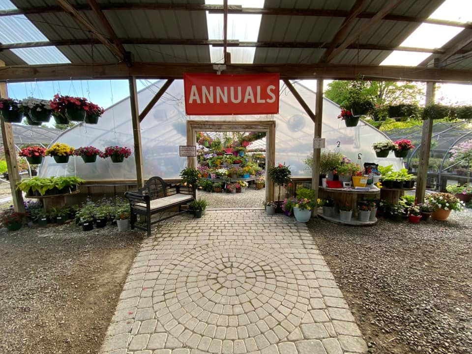 Entrance to a greenhouse labeled 