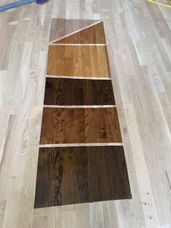 There are many different shades of wood on the floor.