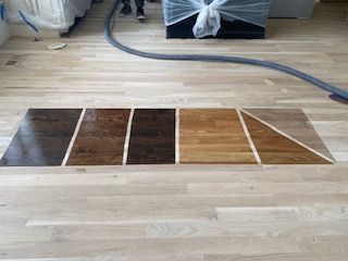 A wooden floor with a vacuum hose attached to it.