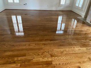 A living room with hardwood floors and white walls.