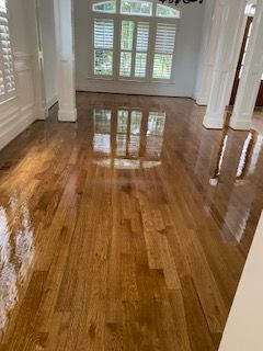 A living room with hardwood floors and a chandelier.