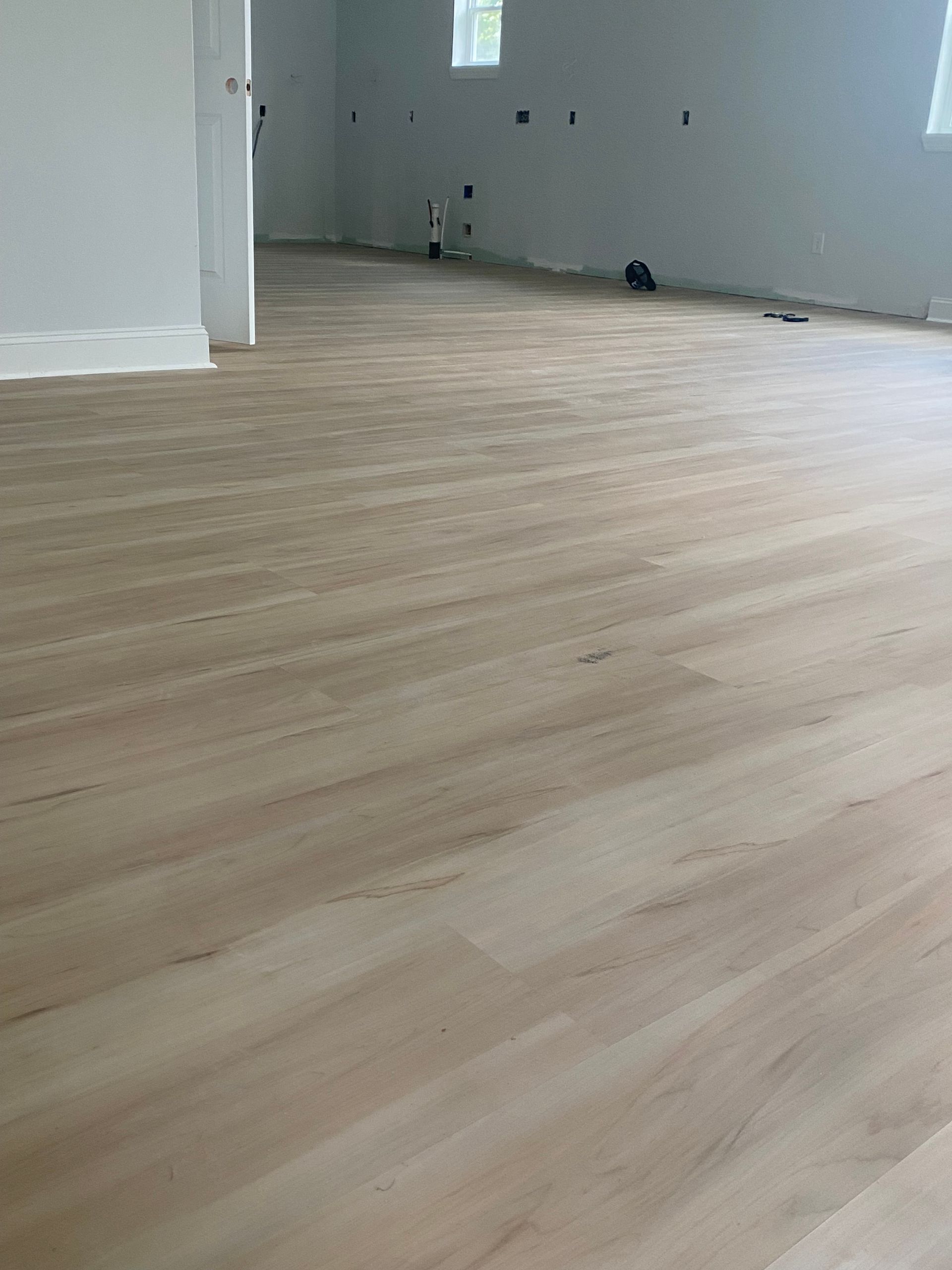 A bed is sitting on a wooden floor in a bedroom.