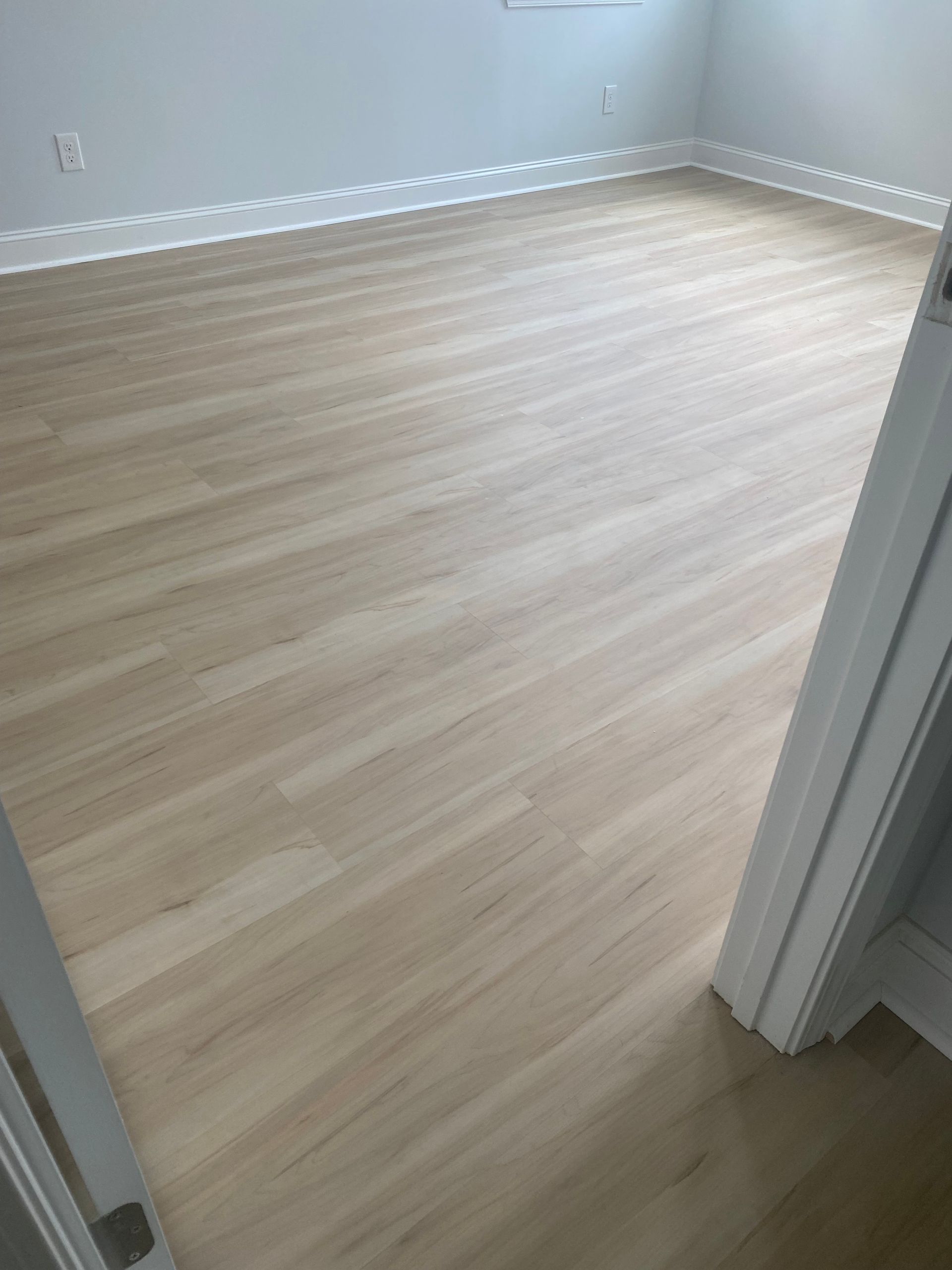 A room with a wooden floor and white walls.