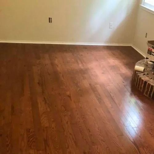 A room with hardwood floors and white walls.