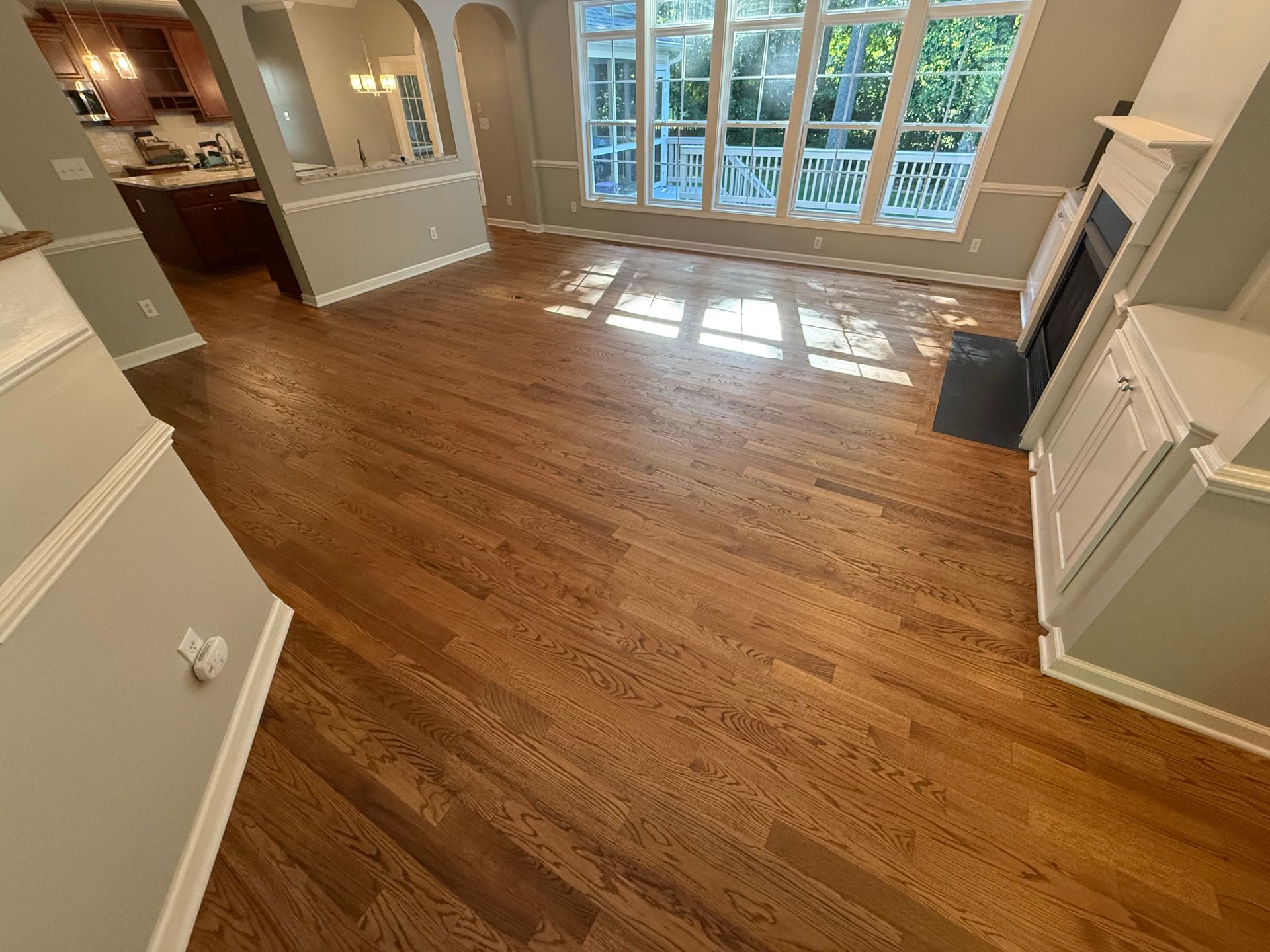 A living room with hardwood floors and a fireplace.