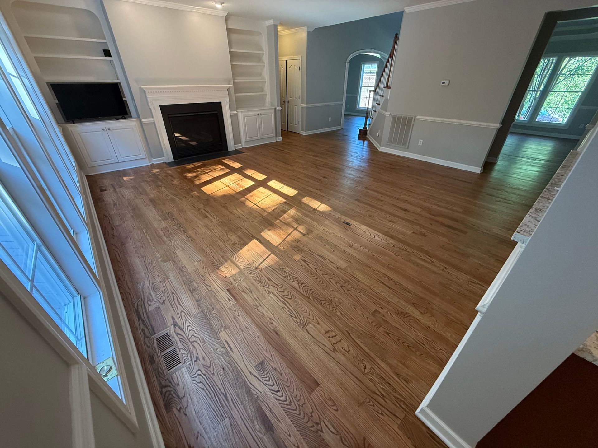 A living room with hardwood floors and a fireplace