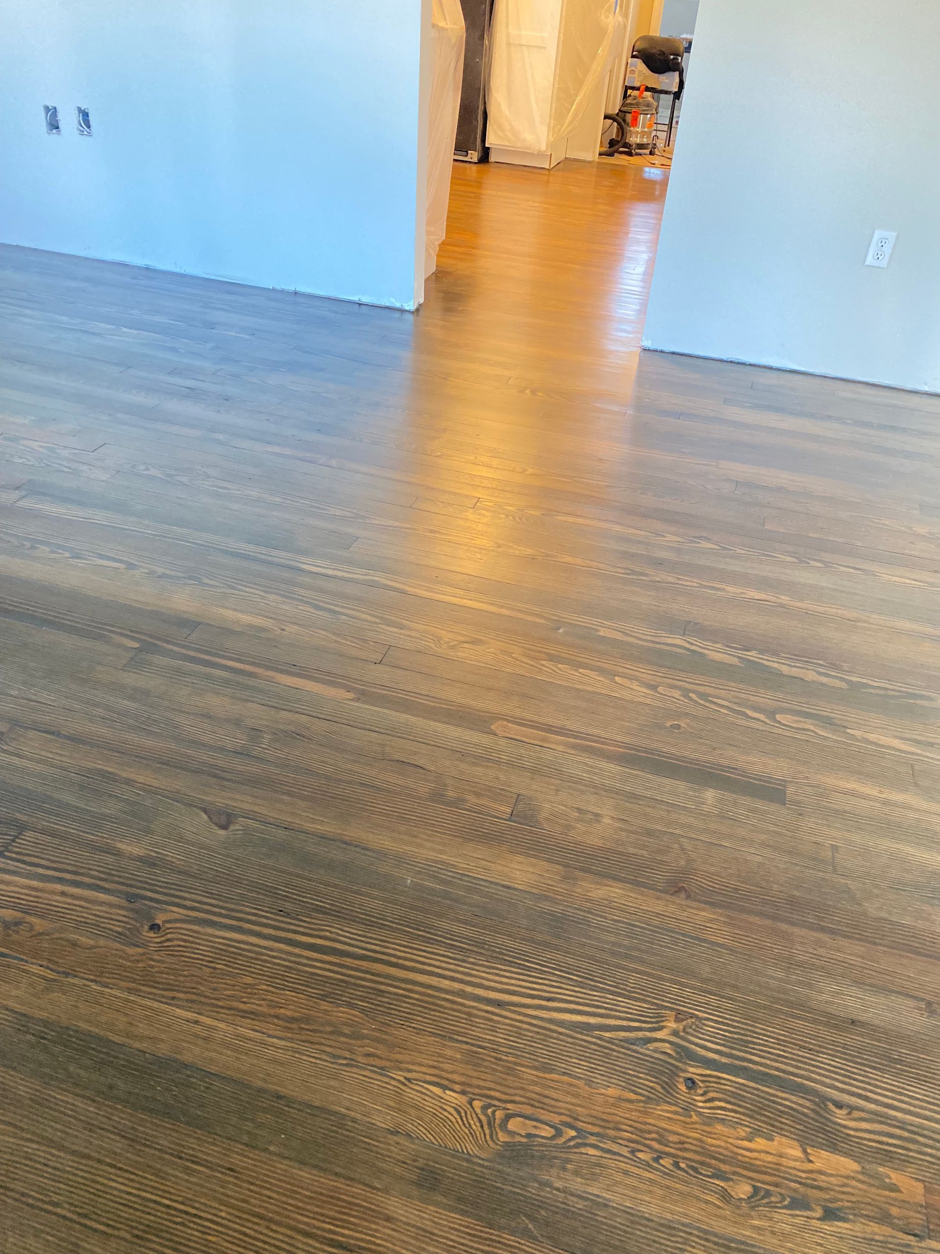 A close up of a wooden floor in a room.