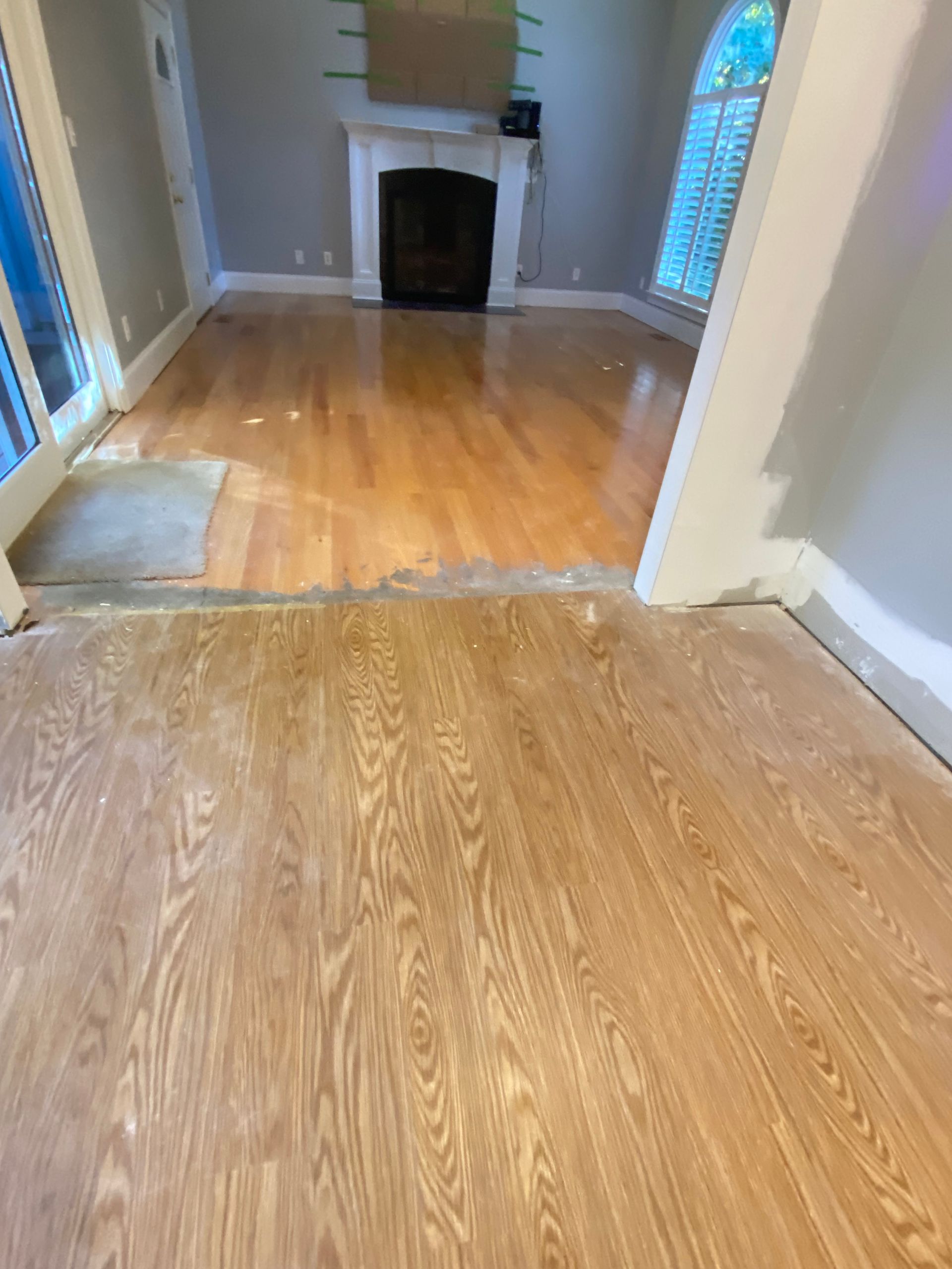 A living room with hardwood floors and a fireplace.
