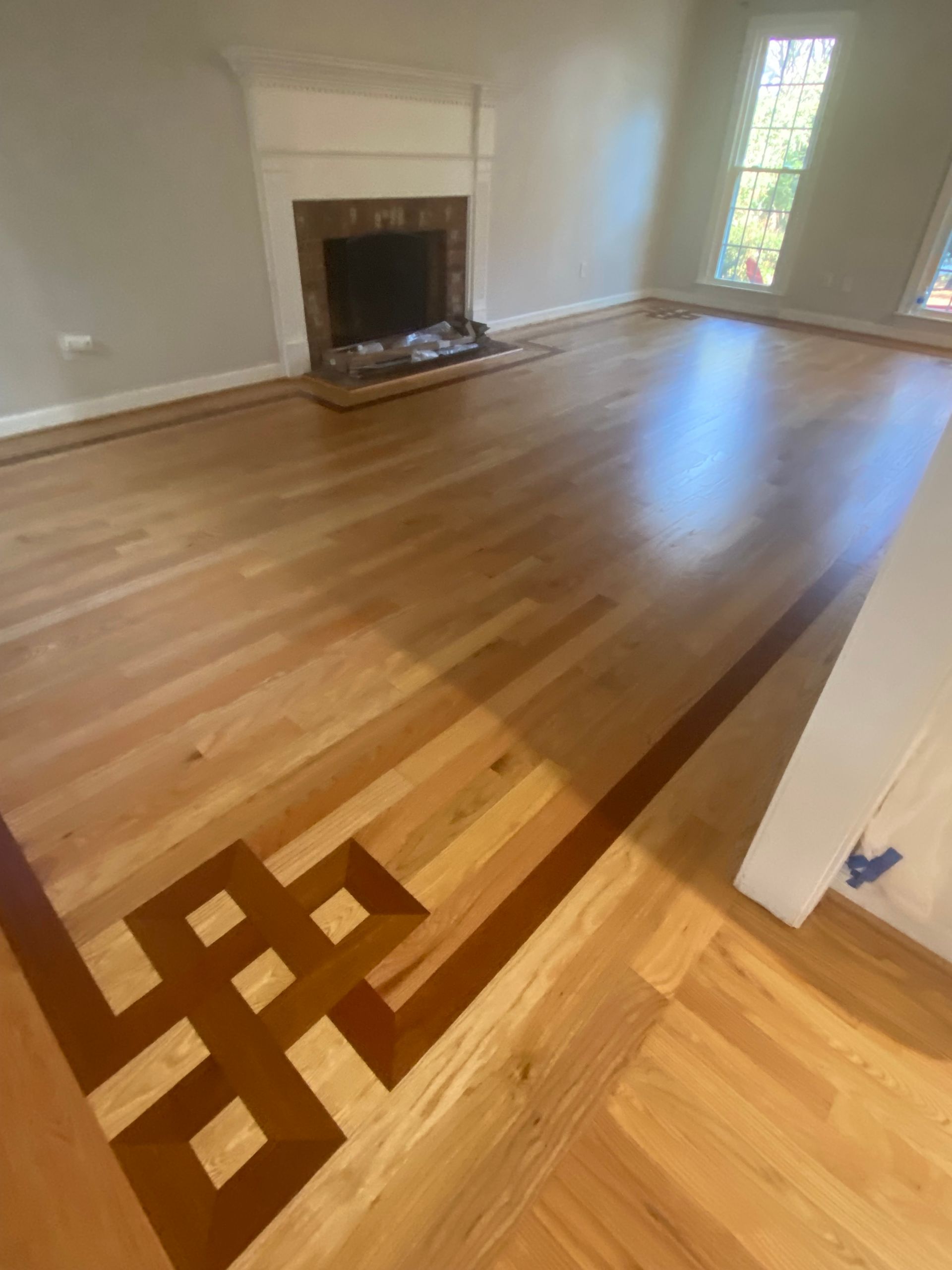 A living room with hardwood floors and a fireplace