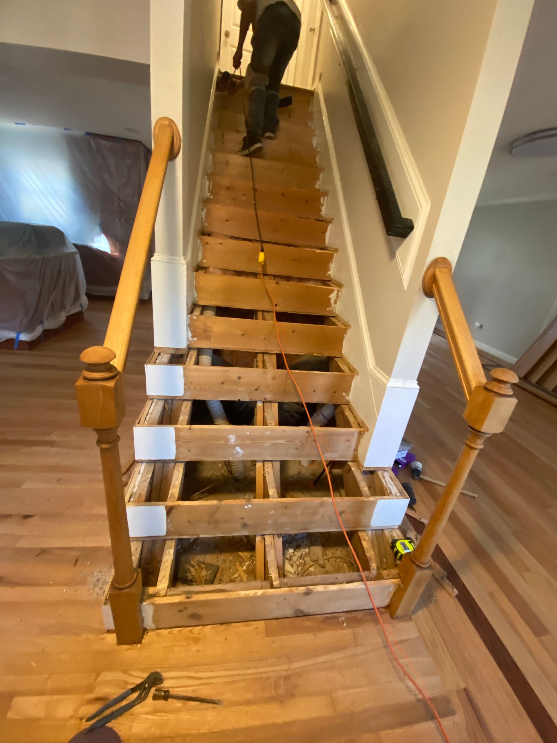 A man is working on a set of wooden stairs