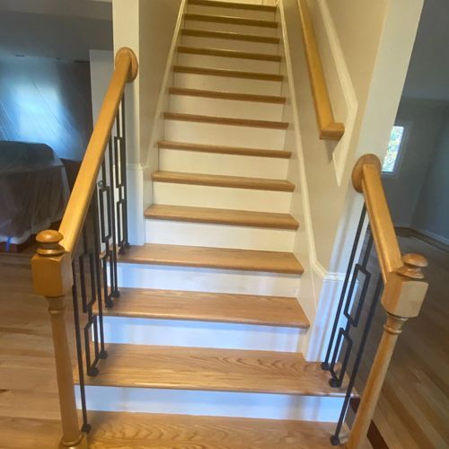 A staircase with wooden steps and a metal railing