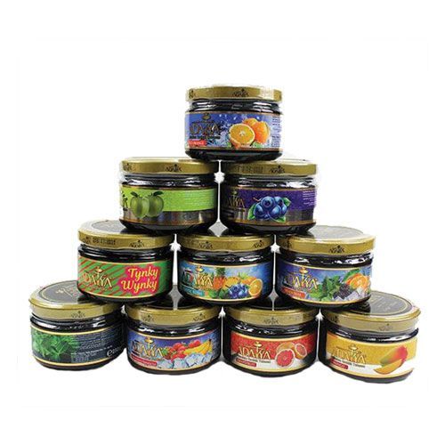 There are many different flavors of hookah tobacco stacked on top of each other.