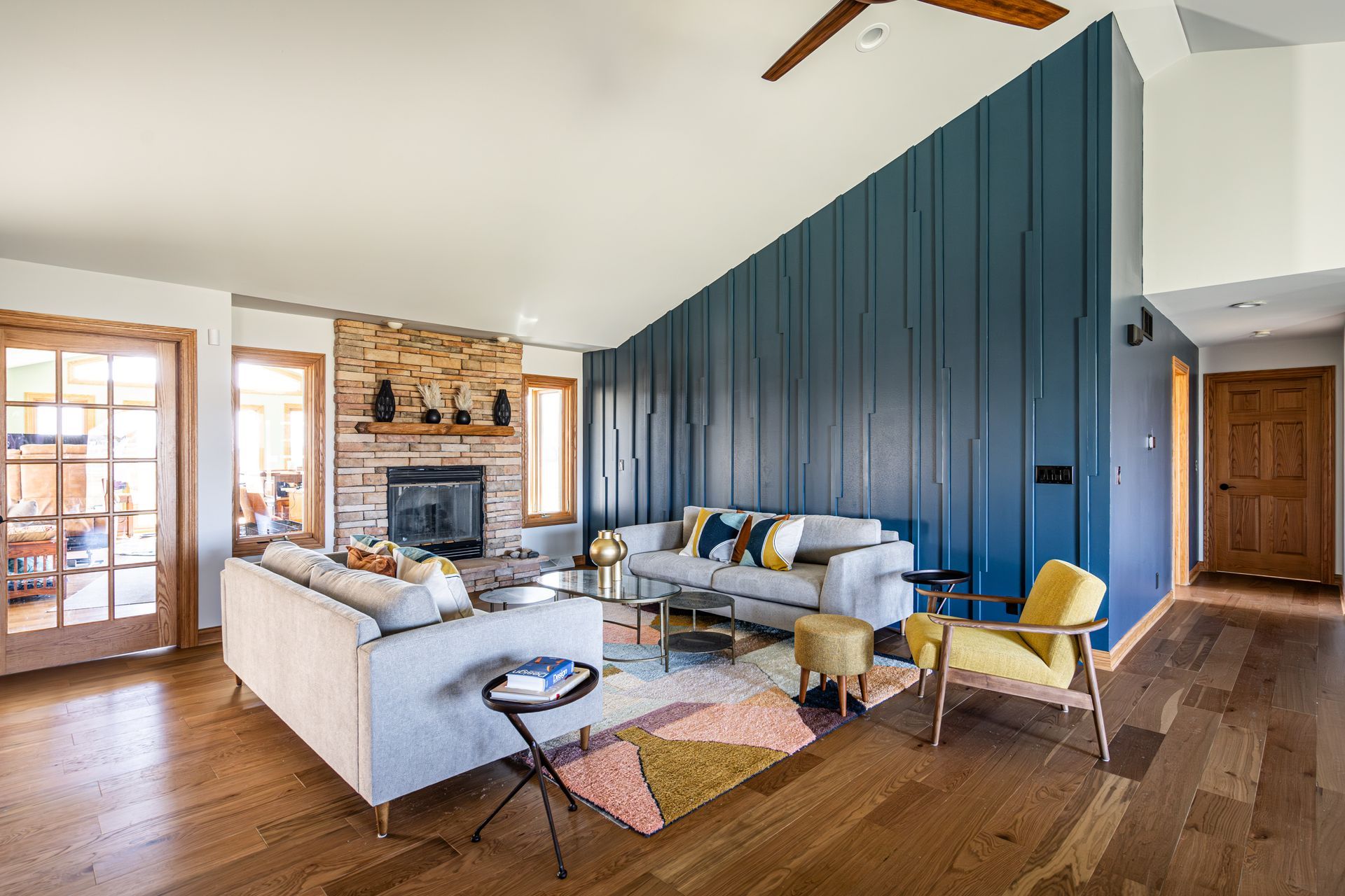 A living room with a couch, chairs, and a fireplace.