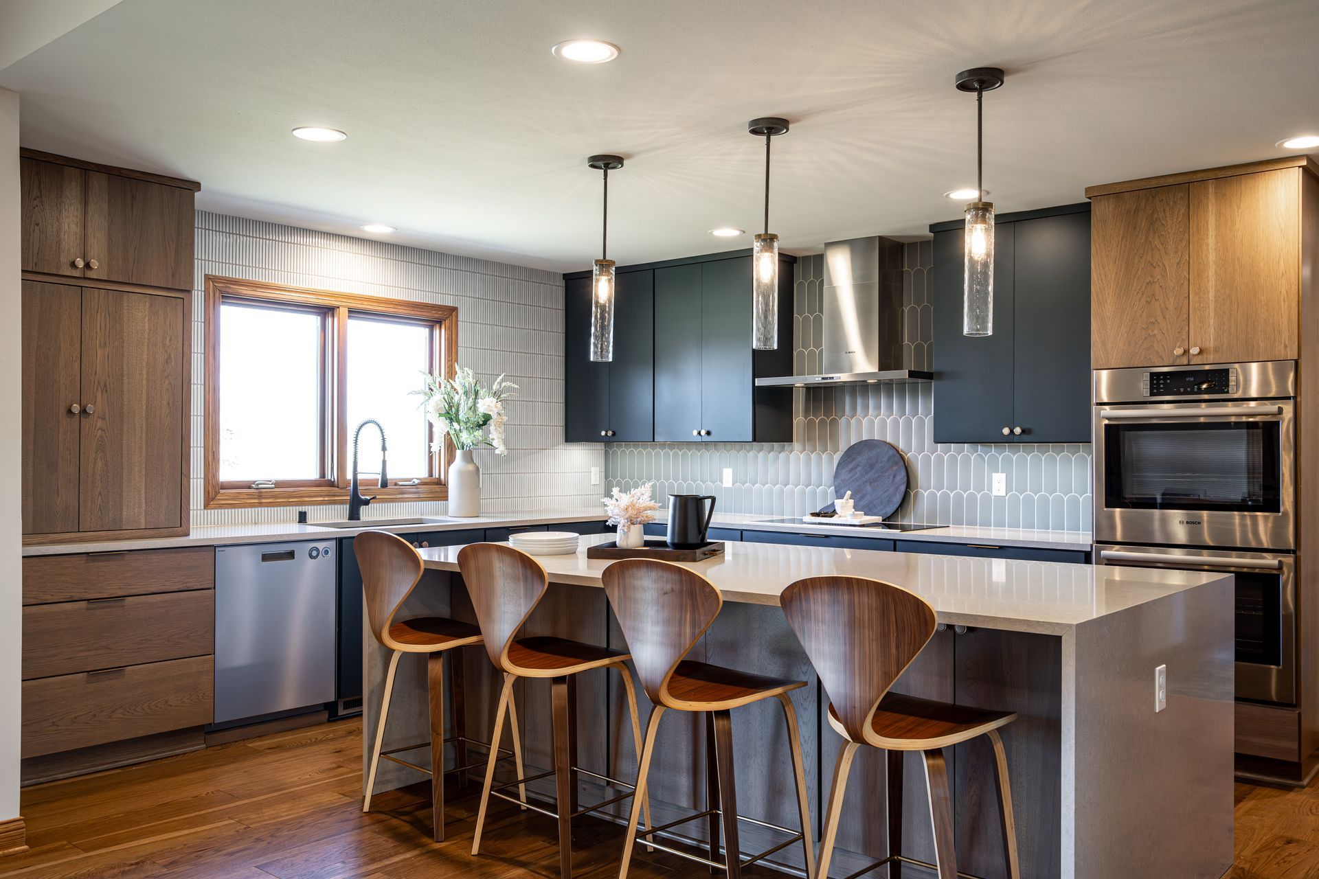 A kitchen with stainless steel appliances, wooden cabinets, and a large island.