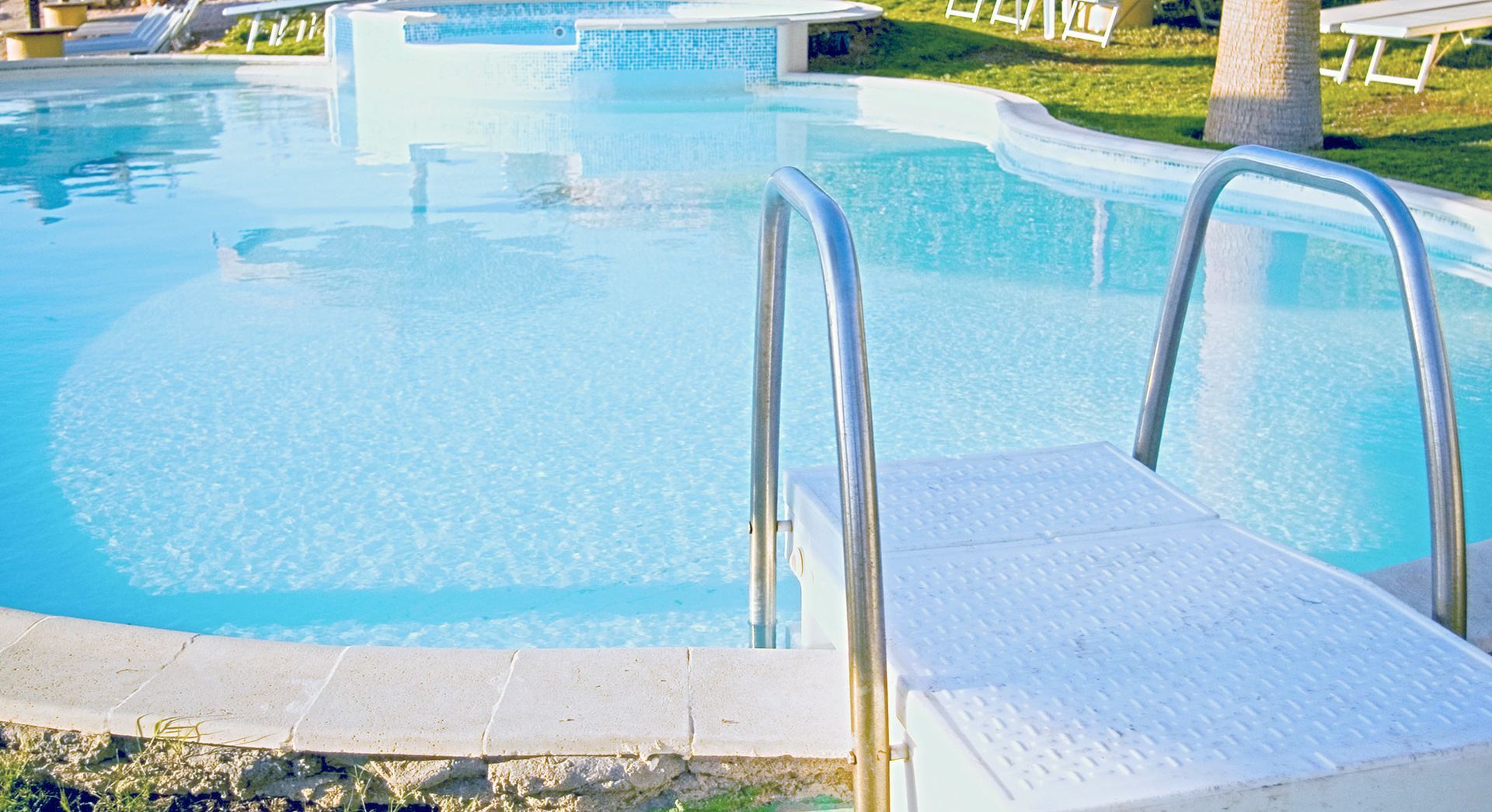 A swimming pool with stairs leading up to it.