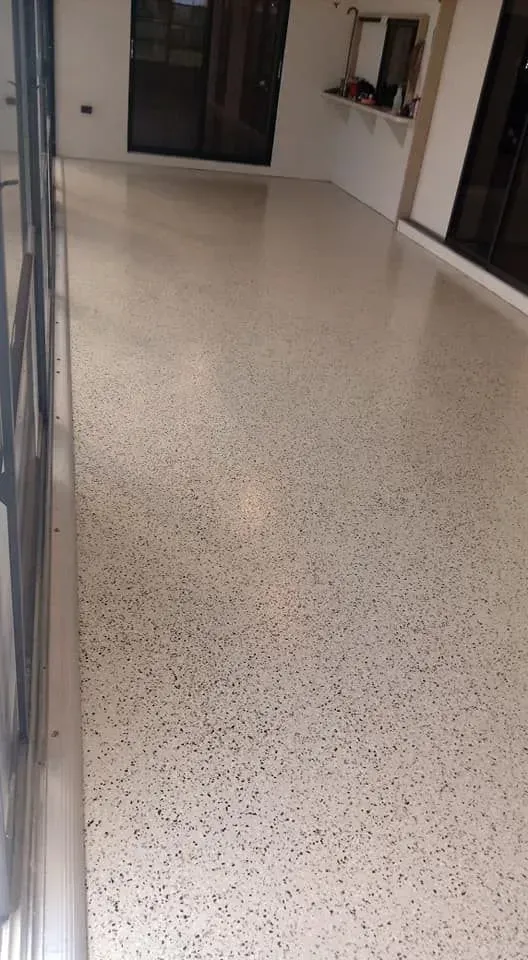 Tan terrazzo floor in a brightly lit indoor space.
