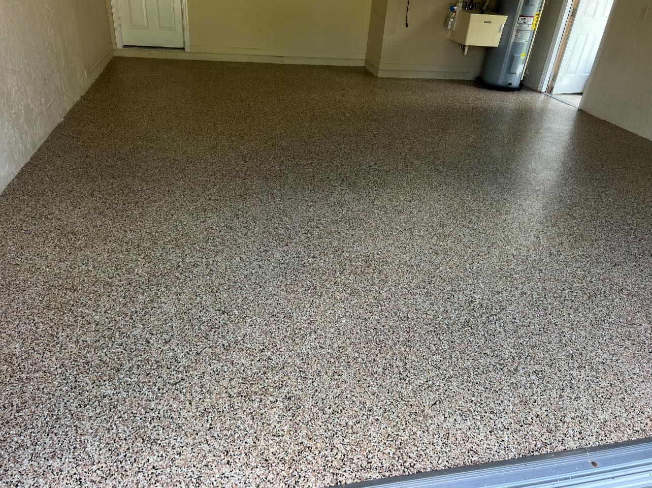 Epoxy garage floor with brown, gray, and tan flecks.