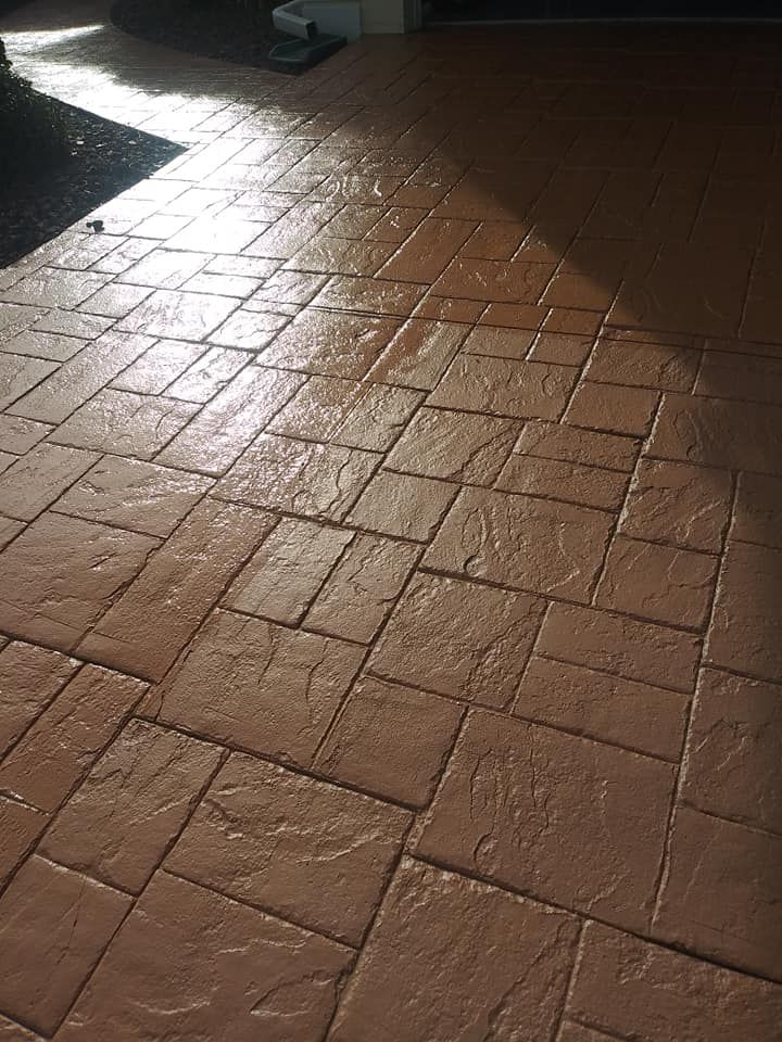 Brown stamped concrete patio with a glossy finish.