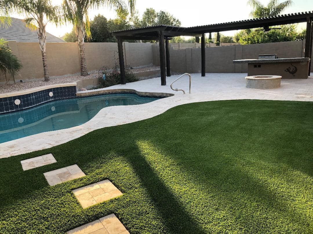 Backyard with a pool, patio, lawn, pergola, barbecue, and fire pit.
