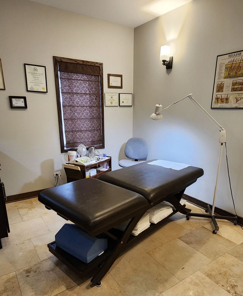 A facial bed in a room with a lamp