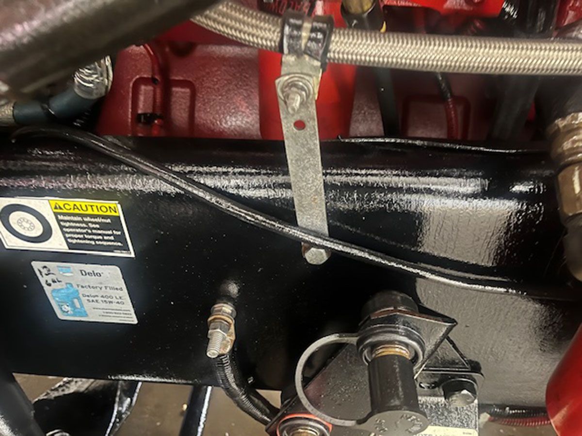 A close-up of an engine with a caution sign on it