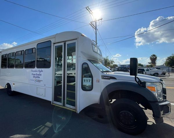 A white bus is parked on the side of the road.