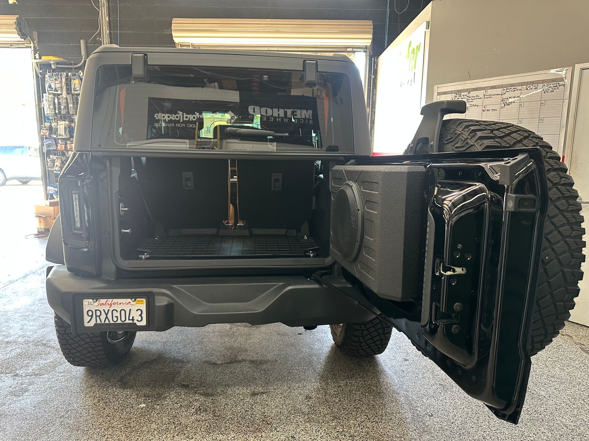 A jeep with the trunk open and a California license plate