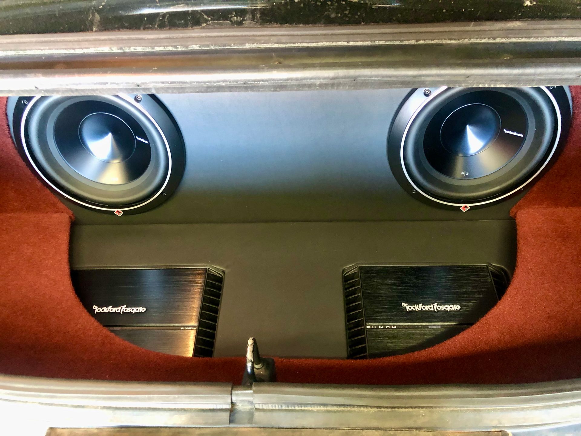 A pair of rockford fosgate speakers in the back of a car